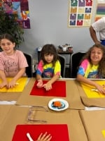 Camper smiling at an activity table