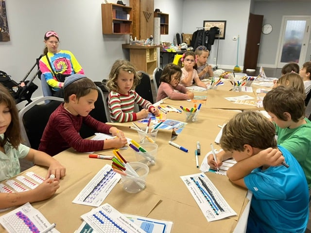 Campers seated around a table for a hands-on activity