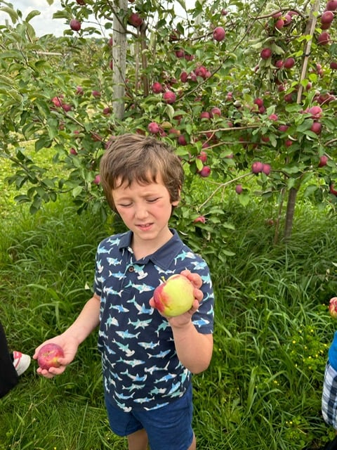 Camper smiling outdoors during a camp trip