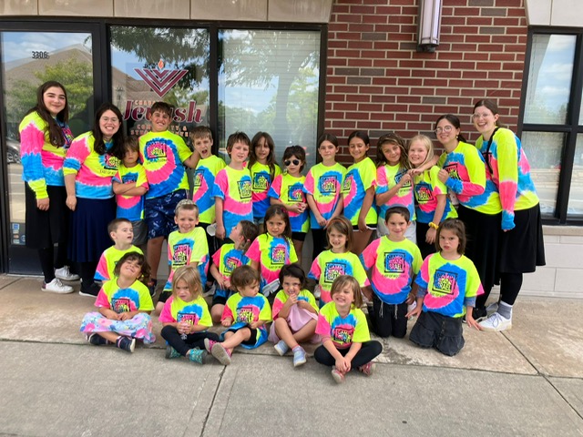 Campers and staff smiling together outside