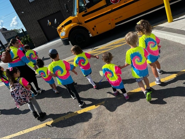 Campers walking together near a school bus